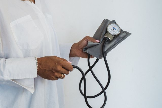 Woman Holding a Blood Pressure Monitor